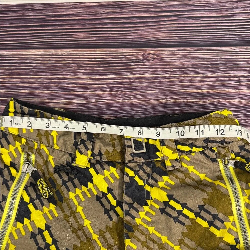 SPYDER Boys' Propulsion ski pants with an olive, black, and yellow plaid pattern